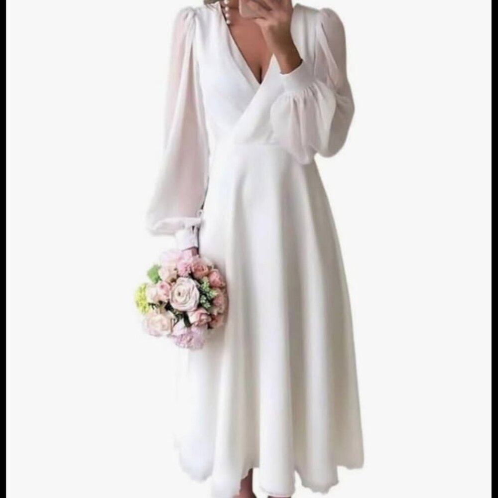 Women's long sleeved tea length bridal dress.